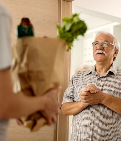 senior man receiving groceries